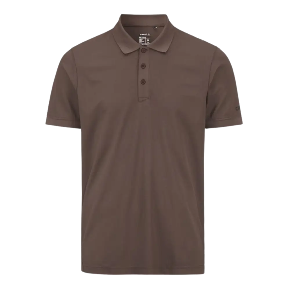Craft CORE Unify Polo pikeepaita, vÀri Real (ruskea). Polo omalla logolla, kuva paidasta edestÀ.
