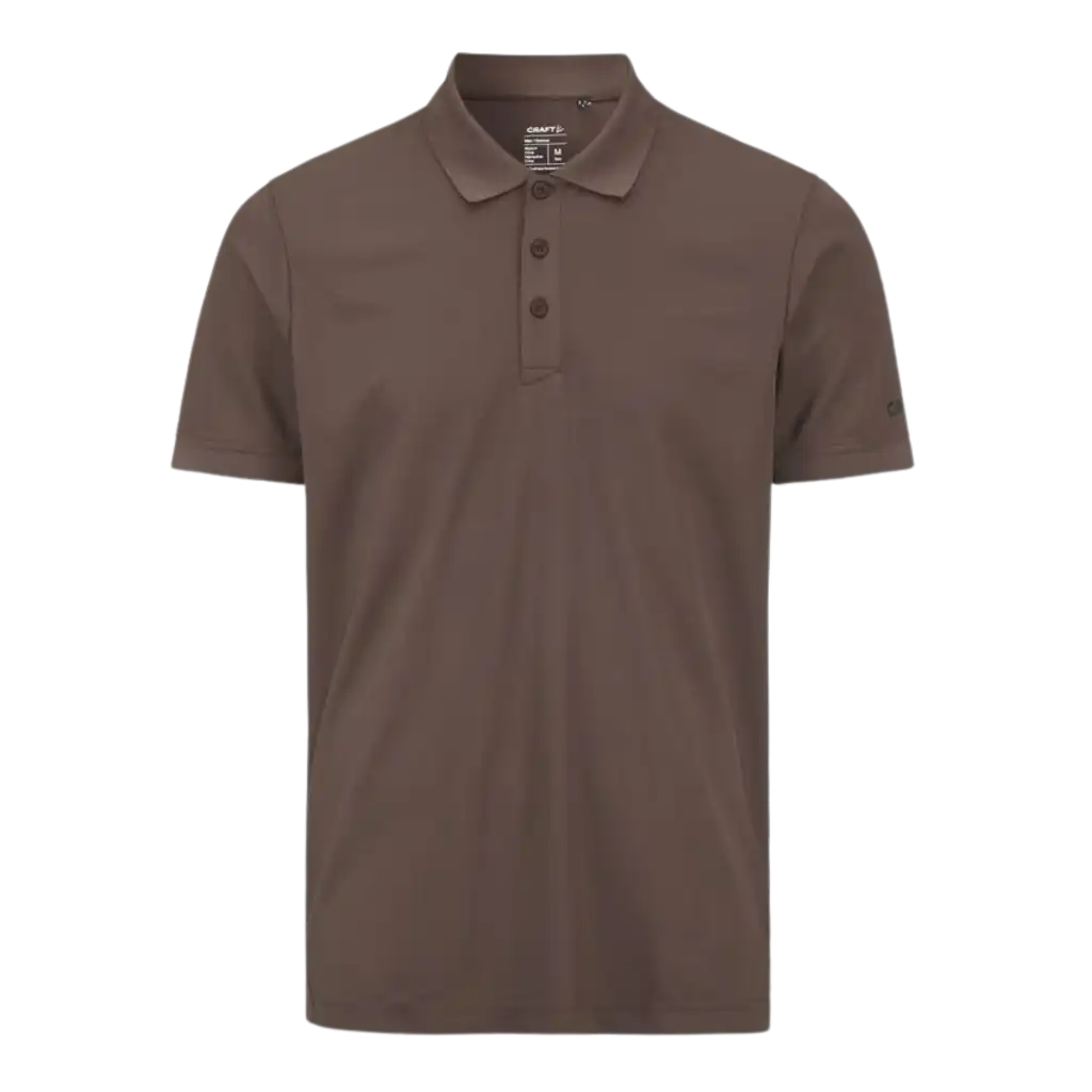 Craft CORE Unify Polo pikeepaita, väri Real (ruskea). Polo omalla logolla, kuva paidasta edestä.