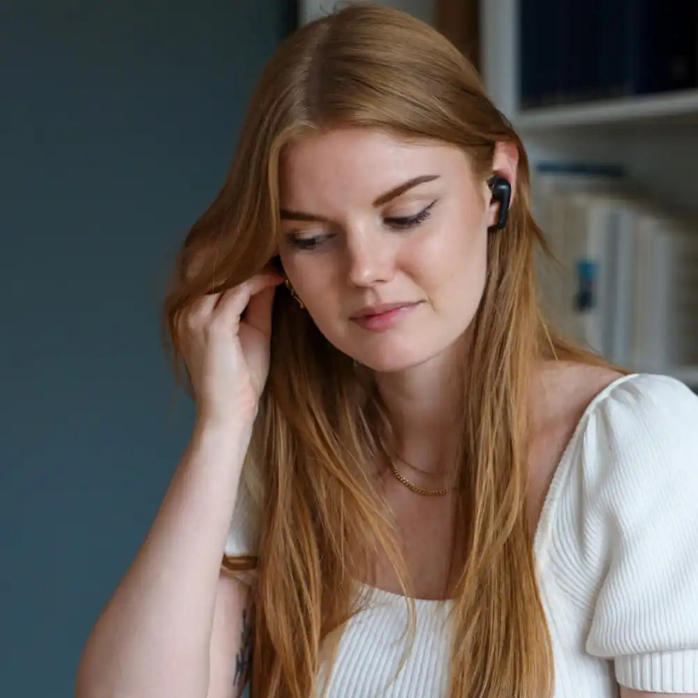 Henkilö puhuu puhelimeen SACKit Active 200 -kuulokkeilla – loistava lahja työkäyttöön